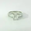 Gabrielle emerald center with graduated trapezoid ring