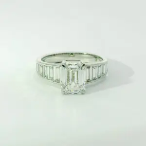 Gabrielle emerald center with graduated trapezoid ring