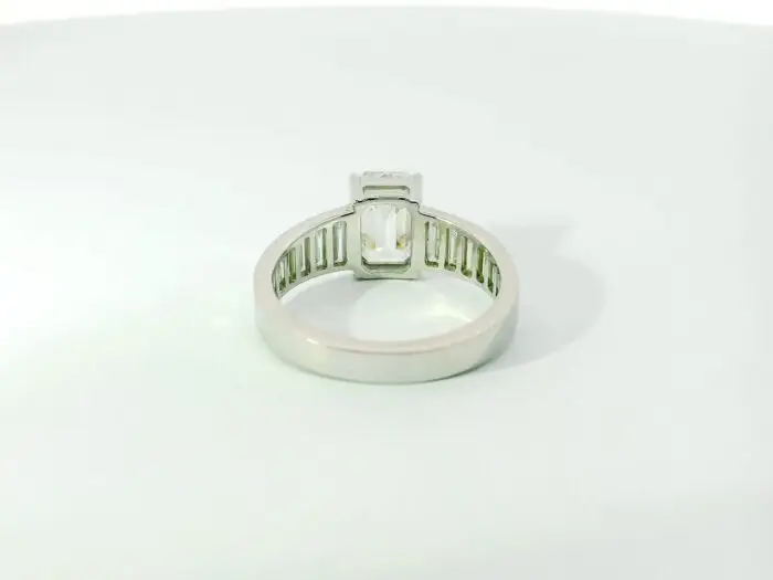 Gabrielle emerald center with graduated trapezoid ring